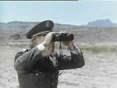 Something must be up. What is the Colonel looking for with his binoculars?!