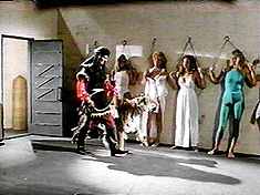 Oh, man, not another "Showgirls/Commandos chained to a Sheik’s wall, menaced by a tiger" scene! Like that’s not in every other movie!