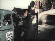 Helen pretends to get hit by a passing rear projection shot.