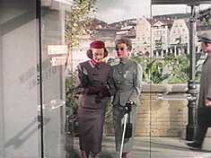 Joyce and Helen enter one of the film’s obvious sets, fronting another blown-up ‘Street Scene’ photo.