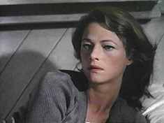 A vampire-like Rampling rises from her slab, er, bed, and offers to warm Nolan. 