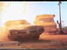 A school bus chasing a black sedan through an inferno. Now there’s something you don’t see everyday.